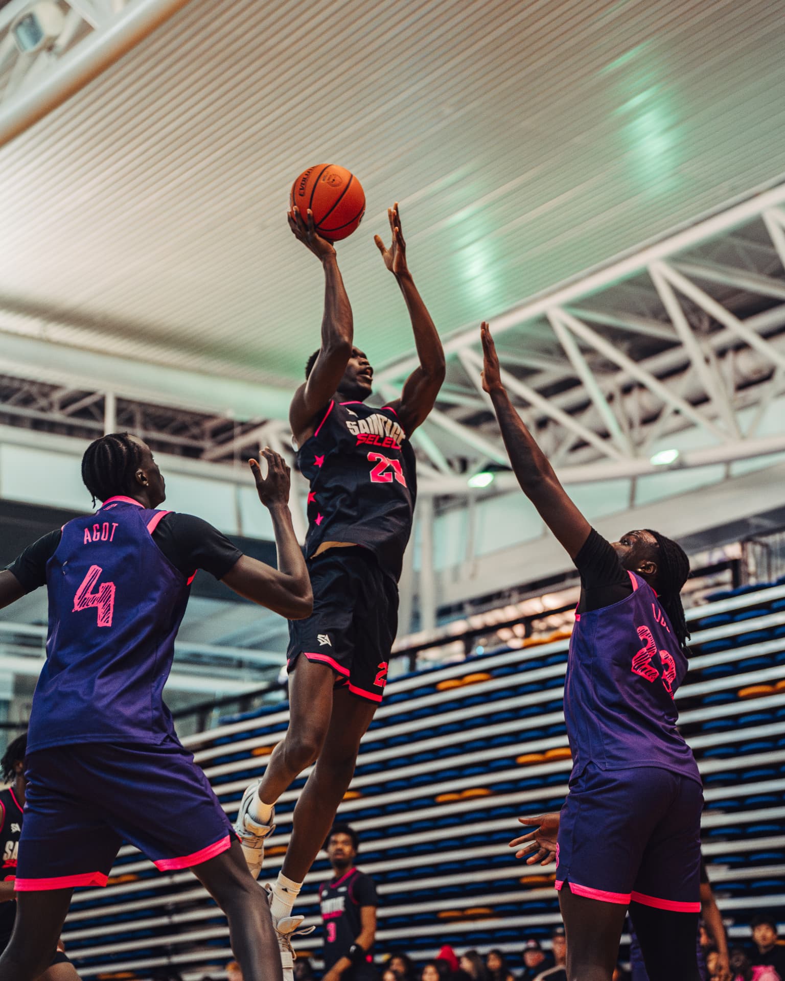Player shooting over two defenders in the paint