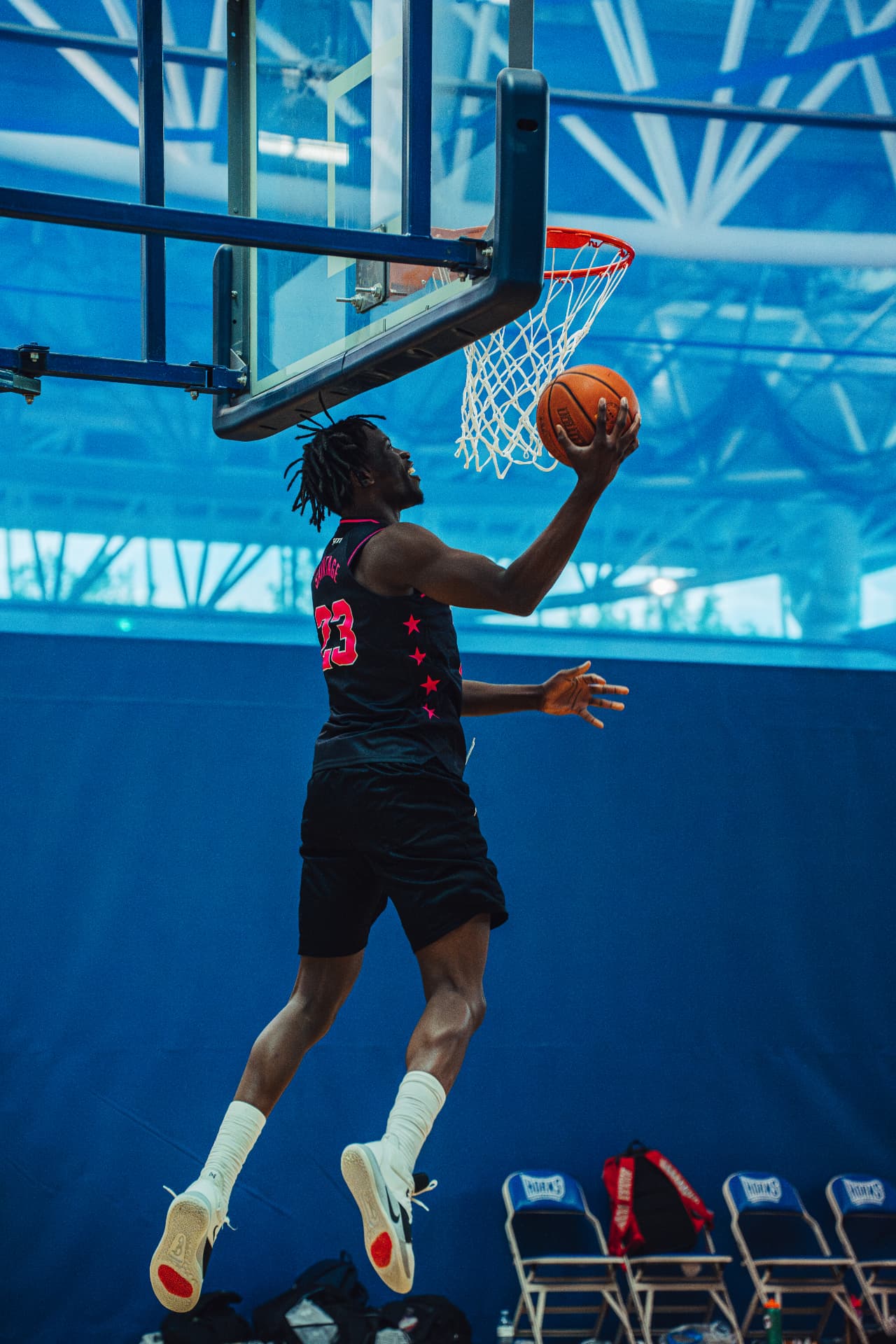 Player finishing a reverse layup at the hoop
